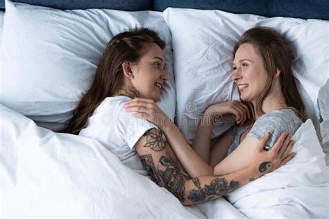 Two Smiling Lesbians Embracing While Lying In Bed Stock Image Image Of Smiling Women 214906145