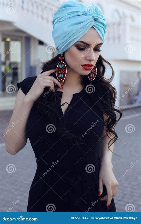 Sensual Woman Wearing Elegant Black Dress And Silk Turban Stock Image