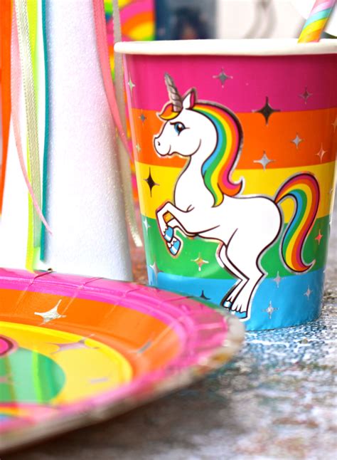 There Is A Cup With A Unicorn On It Next To Other Plates And Napkins