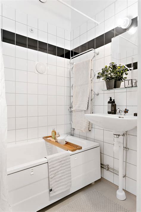 A skirt for the sink provides extra storage underneath and the pages of an old book are taped to the wall for inexpensive and effective decoration. 15 Stunning Scandinavian Bathroom Designs You're Going To Like