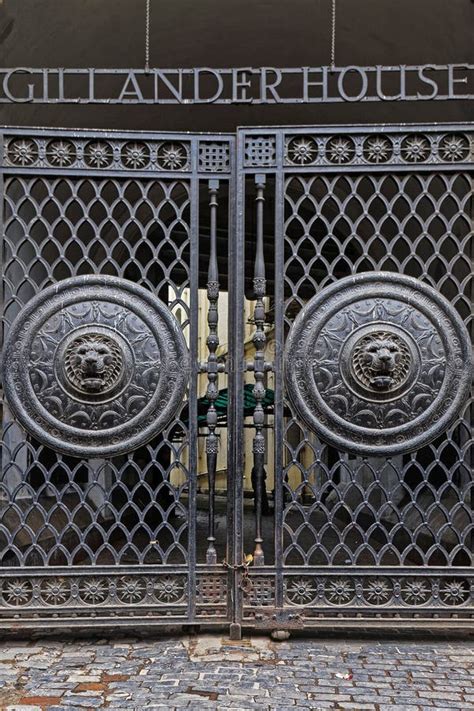 Huge Black Metal Gate At The Main Entrance With Lion Head Embossed On