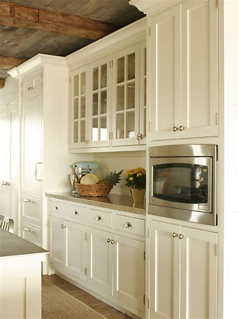 If you want your cream cabinets to have a fun contemporary vibe, blue is the ideal color. Cream Kitchen Cabinets - Country - kitchen - Shelter Interiors LLC