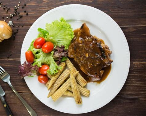 Often, it serves with a hot cast iron plate and while it's still hot. Chicken Chop with Black Pepper Sauce