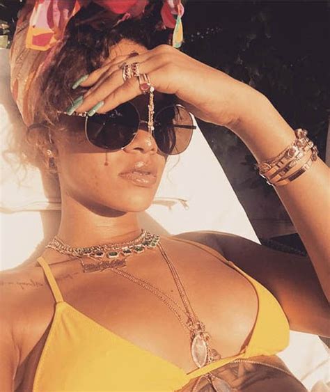 rihanna sunbathes in a yellow bikini in barbados rihanna in pictures celebrity galleries