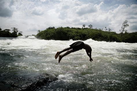Young Man Jumping Into River Photograph By David Sacks