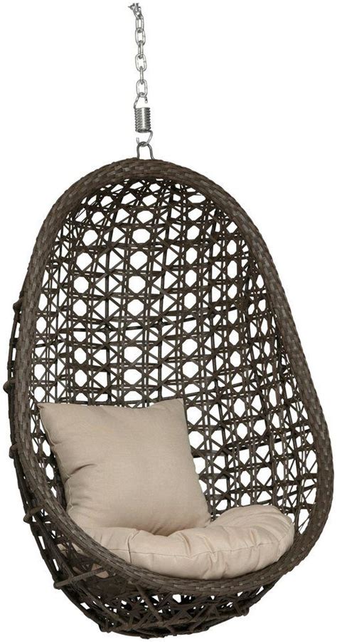 The Hanging Chair Is Made Out Of Wicker And Has A Cushion On Top Of It