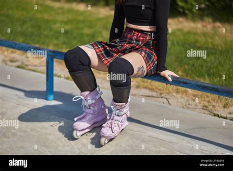 Tattooed Roller Blader Girl Sitting On A Rail In A Skatepark Cool