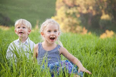 Image Of Happy Children Sitting Together In Long Green Grass Austockphoto