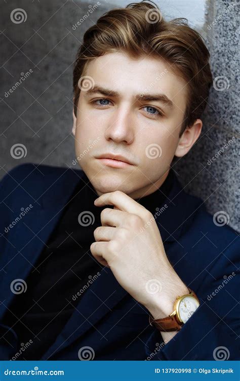 Portrait Of An Attractive Man In A Suit And A Black Sweater Close Up