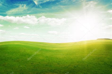 Green Grass Hills Under Midday Sun In Blue Sky Stock Photo By Logray