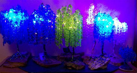 Some Blue And Green Trees Are Lit Up In The Dark Room With Purple
