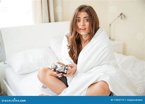 Scared Woman Holding Alarm Clock On The Bed Stock Image Image Of