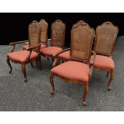 A silver vintage style dining table sits at the center of the space. Set of Six French Country Oak Cane Dining Room Chairs by ...