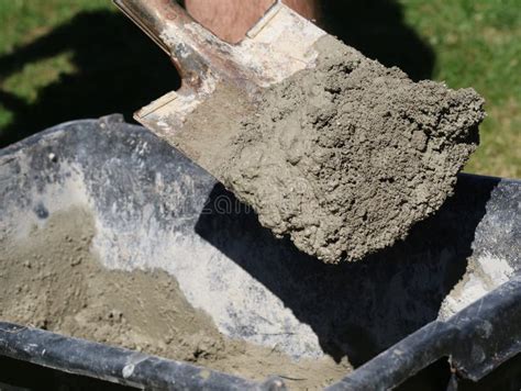Concrete Mortar Mixed In Black Bucket With Spade By Worker In Garden