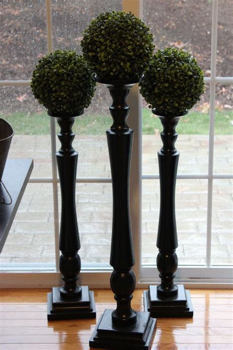 The stand b is composed of fretwork; Like the topiary balls on top of the wooden candlesticks ...