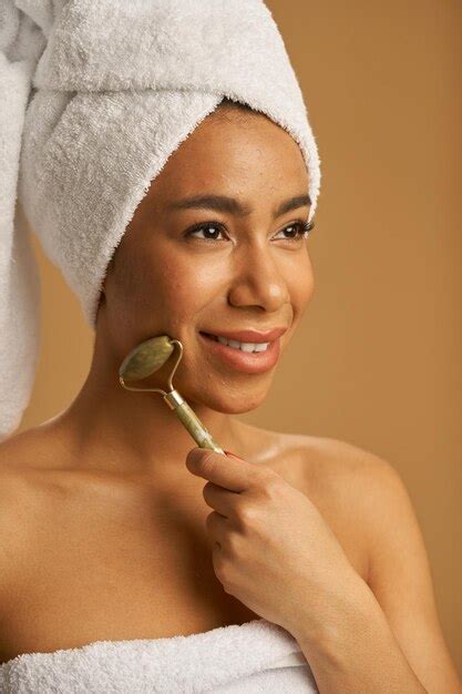 Premium Photo Portrait Of Cheerful Mixed Race Young Woman After Shower Smiling Away While