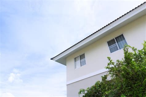 Premium Photo House Roof With Large Windows On Blue Sky