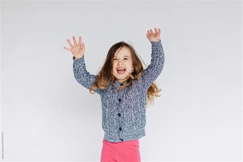Cute And Sassy Young Girl Dancing In Front A White Wall By Stocksy