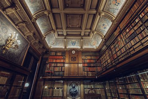 A Large Library Or Study Filled With Lots Of Books Ornate Ceilings And