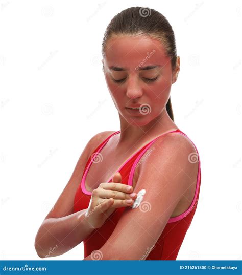 Woman Applying Cream On Sunburn Against White Background Stock Photo