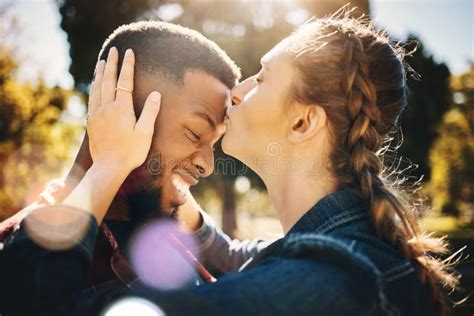 Interracial Couple Forehead Kiss And Smile In Nature For Love Bonding