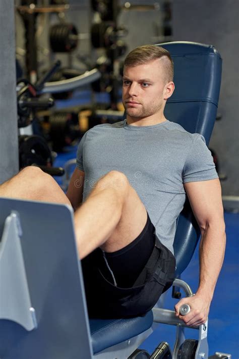Man Flexing Leg Muscles On Gym Machine Stock Photo Image Of Male