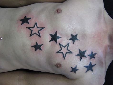 Brown ink three star tattoos on front shoulder. Star Tattoo Designs For Men