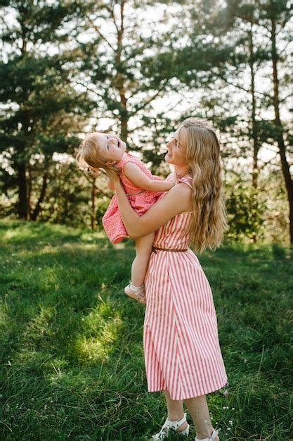 Premium Photo Portrait Of A Mother Holds Throws Up And Spins The