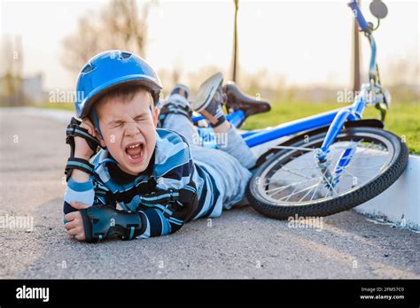 A Small Child Fell From A Bicycle Crying And Screaming In Pain Stock
