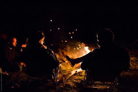 friends enjoying their time around campfire by stocksy contributor boris jovanovic stocksy