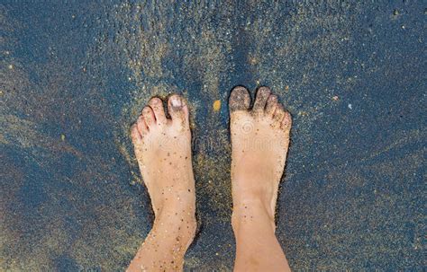 Caucasian Person Feet Foot Standing On Black Volcanic Sandy Beach Stock