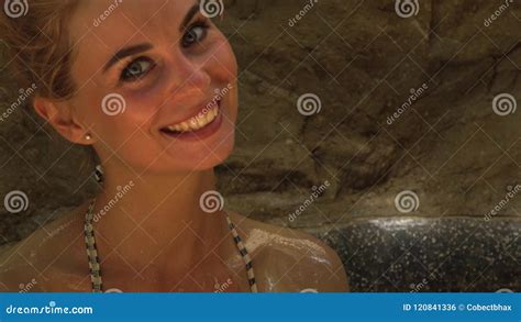 Smiling Woman Taking Mud Bath In Spa Center Beautiful Woman Bathing In Mud Spa And Pouring Body