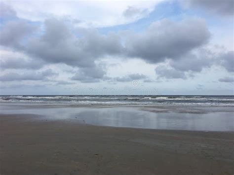 Gray Beach Chairs And Parasols On Sandy Beach With Cloudy Blue S Stock