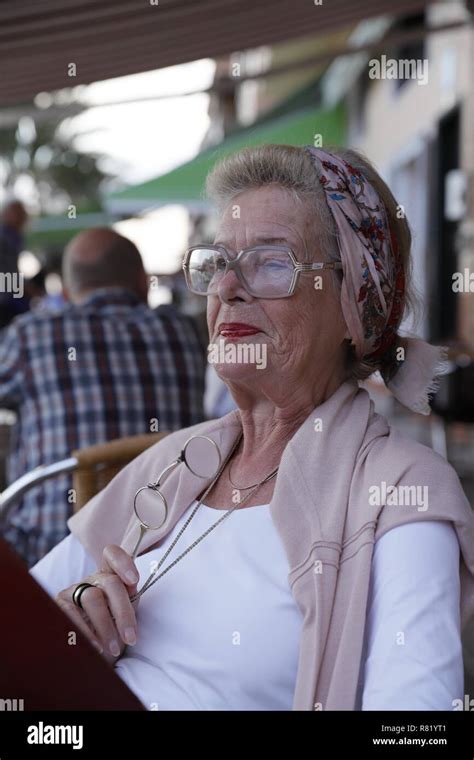 Attractive 78 Year Old Woman During A Summer Restaurant Visit