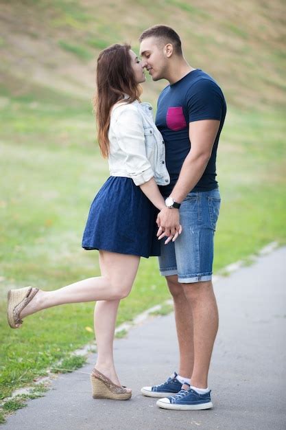Premium Photo Couple Kissing And She With One Leg Raised