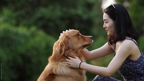Young Asian Woman With Dog Outdoor By Stocksy Contributor Bo Bo