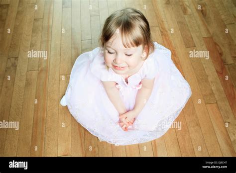 A Nice Little Girl Sit On The Floor With A Dress Stock Photo Alamy
