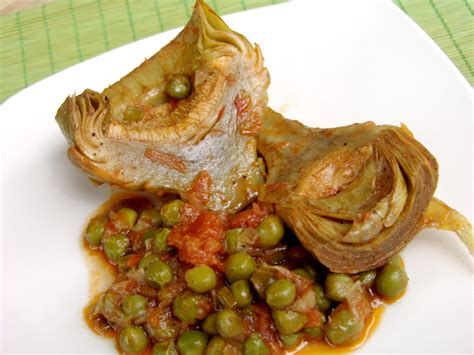 Artichokes With Green Peas In Tomato Sauce Cooking In Plain Greek