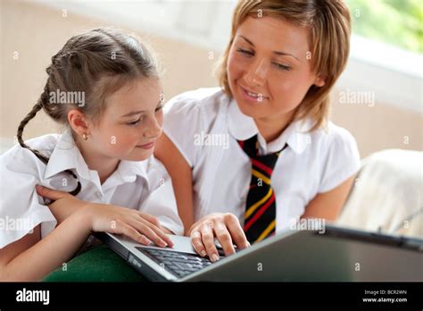 2 Girls Using On Laptop Stock Photo Alamy
