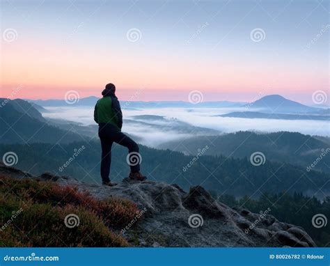 Hiker Man On Rock Watch Over Creamy Mista And Foggy Morning Landscape