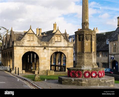 The War Memorial With Poppy Wreathes By Old 17th Century Market Hall In