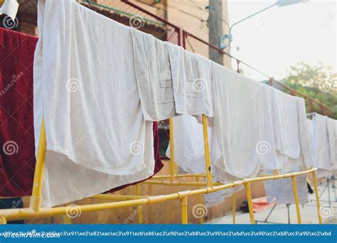 Drying Clothes In The Unusual Sunset White Towels And Sheets Dry In