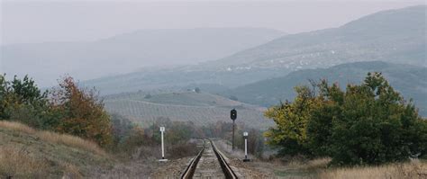 Download Wallpaper 2560x1080 Railway Rails Hills Fog Dual Wide 1080p