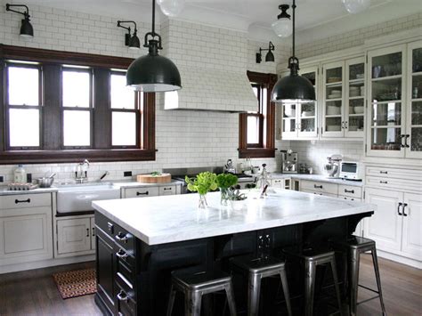 Kitchen cabinet refinishing is reached by staining or painting the cupboard and cabinetry doors. Traditional Kitchen in White Subway Tile With Black Island | HGTV