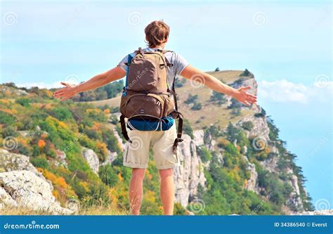 Man Traveler With Backpack Standing Outdoor Hands Raised To The Blue
