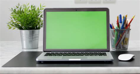 4k A Laptop Computer With A Key Green Screen Set On Work Office Table