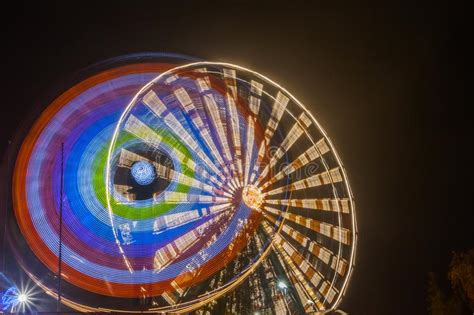 Ferris Wheel In Motion At The Amusement Park Night Illumination Long