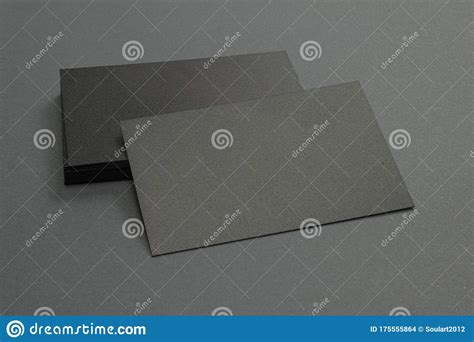 Stack Of Black Blank Textured Business Cards On Dark Paper Background