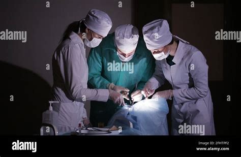 Surgeons Team Preforming Operation In Hospital Operating Theater Close