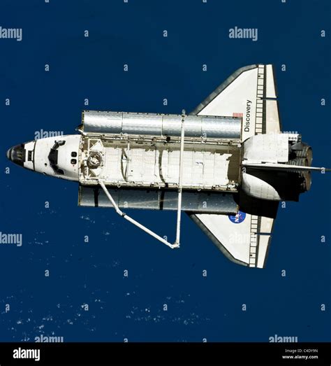 The Hubble The Space Shuttles Discovery Lifting